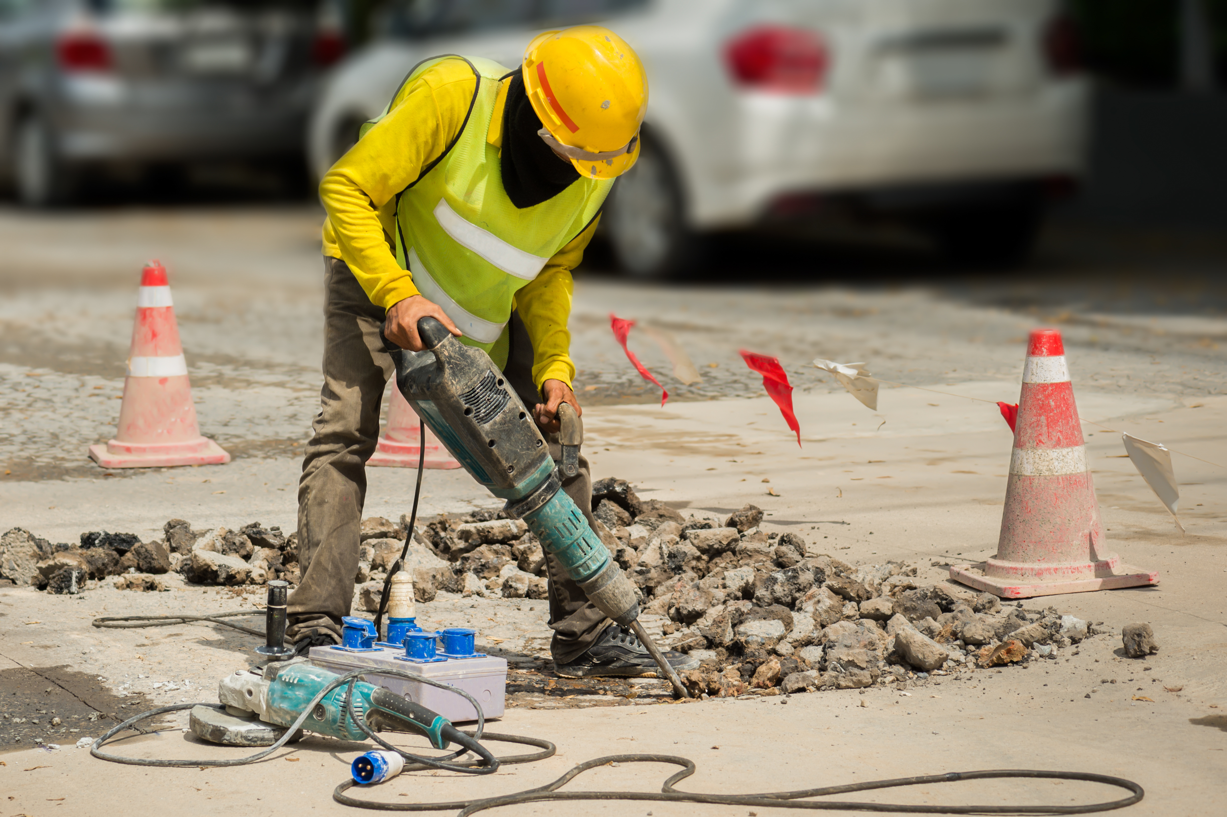 Worker Drilling Concrete Driveway With Jackhammerman Repairing Road 